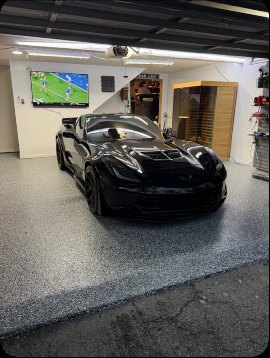 Black Corvette on a charcoal flake man-cave floor