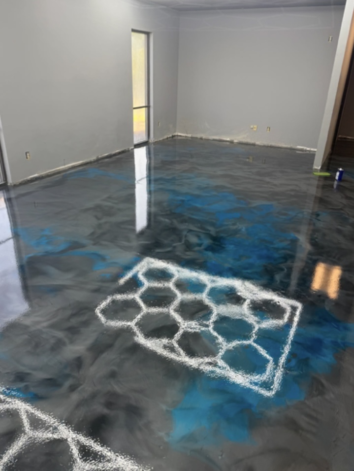 Blue and charcoal metallic epoxy floor with hexagon stencils