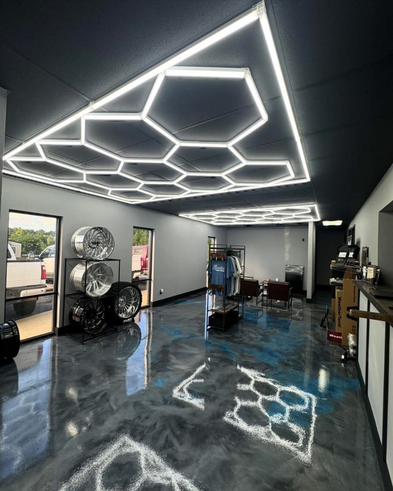 Metallic epoxy showroom floor under hexagon lighting